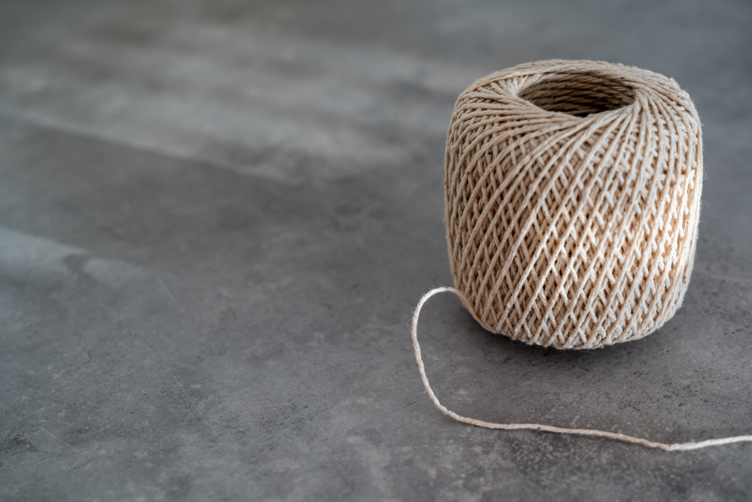 brown-spool-of-rope-on-gray-concrete-floor-3650426